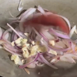 The image shows the onions in the skillet for seafood medley