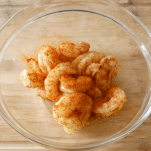 The image shows the process of seasoning shrimp for baja taco recipe
