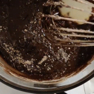 The image shows stirring of ingredients of Ghirardelli Brownies