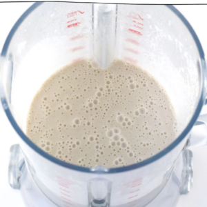 The image shows the ingredients of oat milk ice cream recipe in a blender