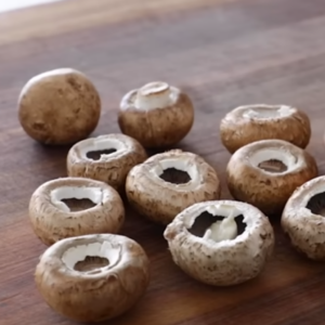 This image shows the process of cleaning and preparing stuffed mushrooms
